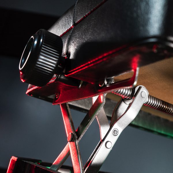 closeup of medal parts holding up seat of Stageline piano bench adjusted to highest height