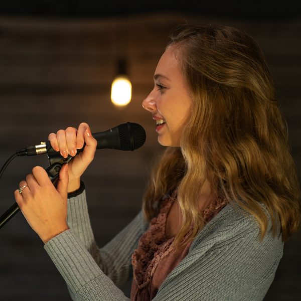 closeup of woman using Stageline microphone stand