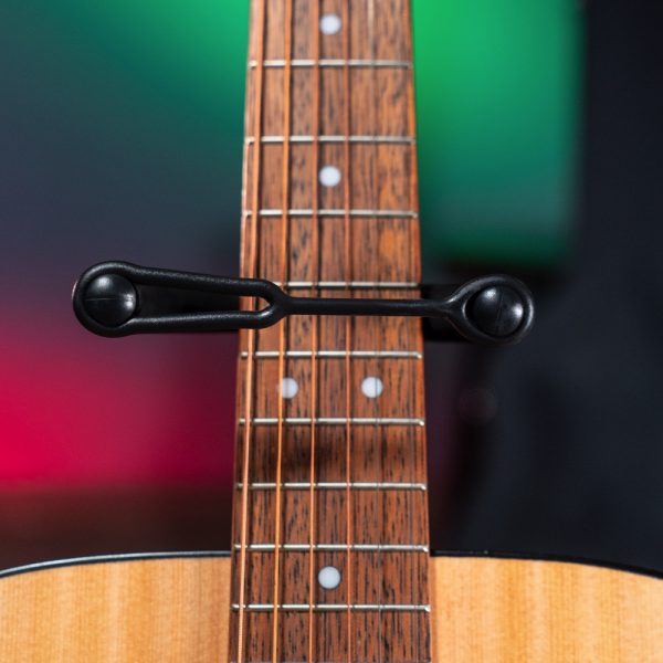 closeup of fretboard of acoustic guitar on Stageline stand